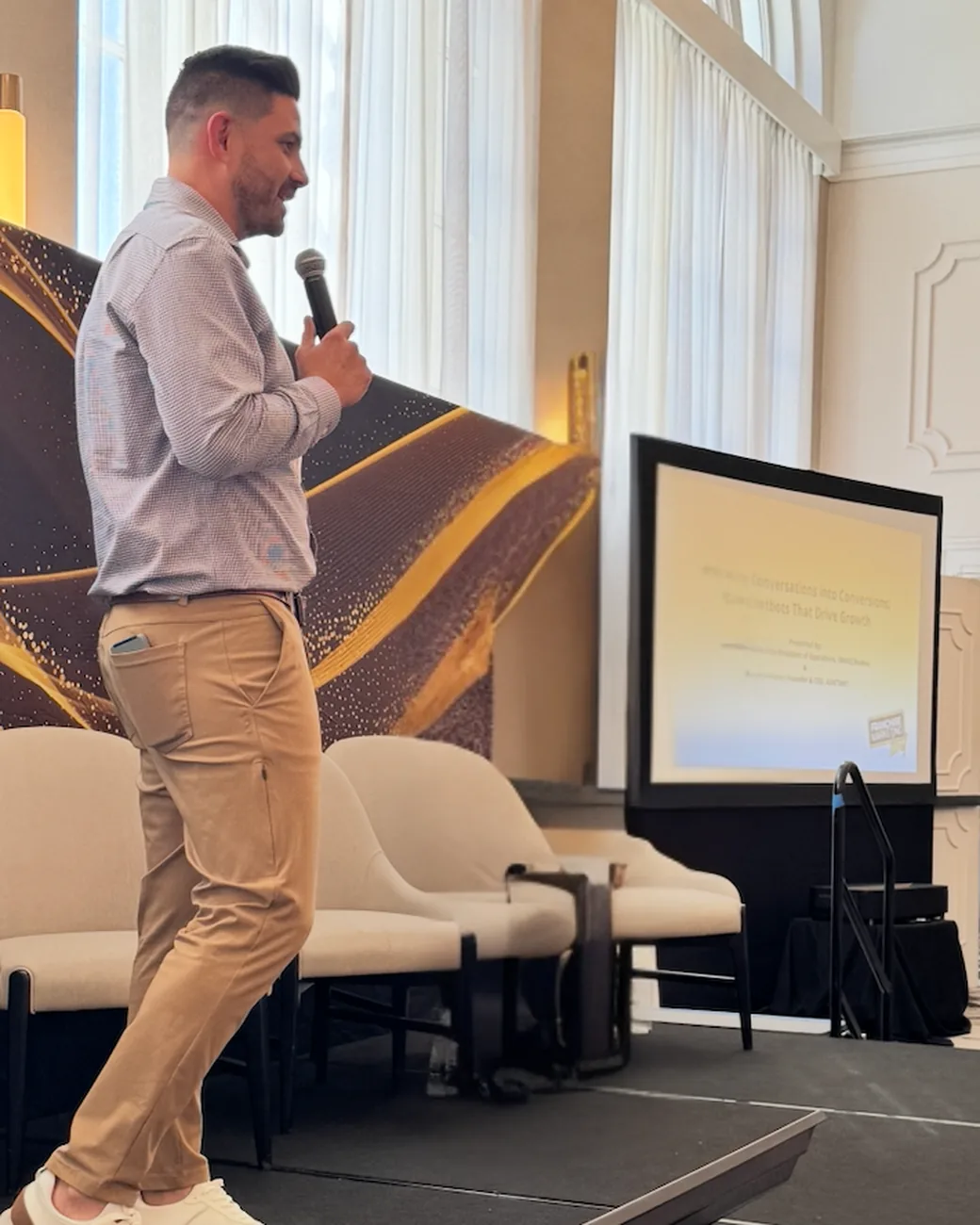 Will Fraker speaking on stage at a franchise conference